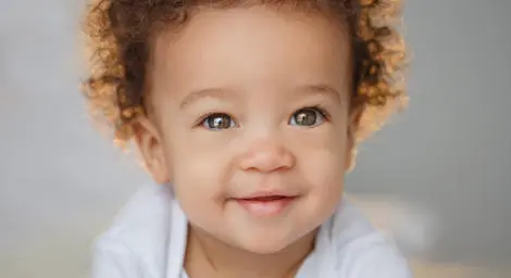 baby-with-curly-hair-smiling