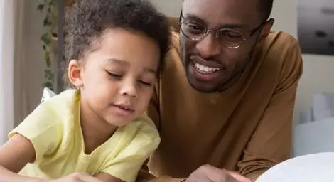 young-boy-and-man-reading