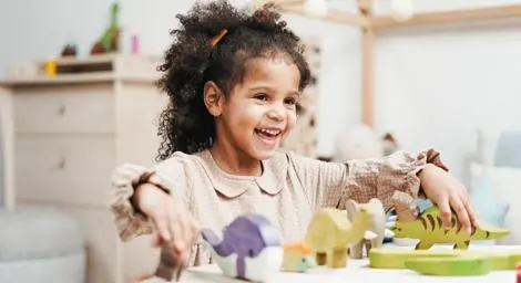 happy-girl-playing-with-dinosaurs